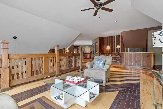 living room featuring ceiling fan and hardwood / wood-style flooring