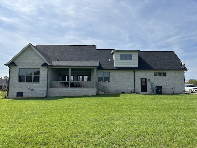 rear view of house with a lawn