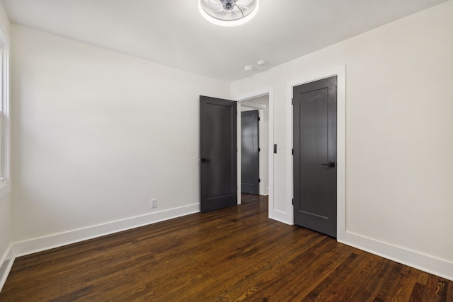 unfurnished bedroom featuring dark hardwood / wood-style flooring