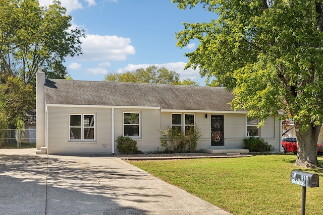 ranch-style home with a front lawn