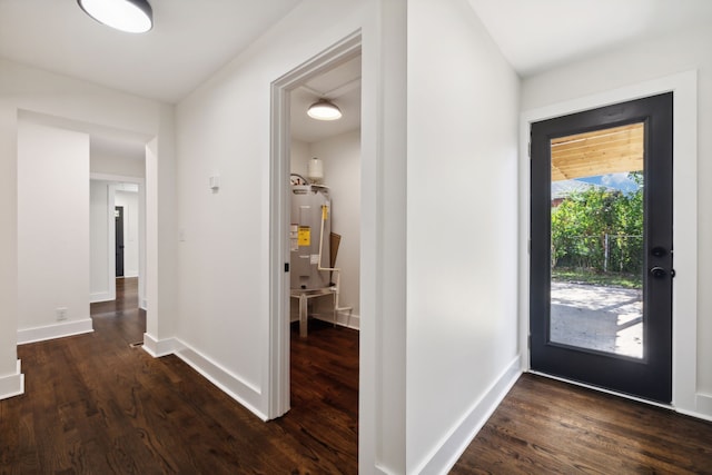 foyer entrance featuring dark hardwood / wood-style floors and water heater