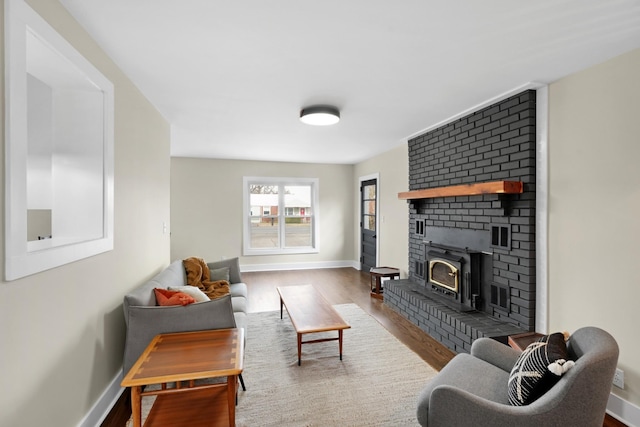 living room with wood-type flooring and a fireplace