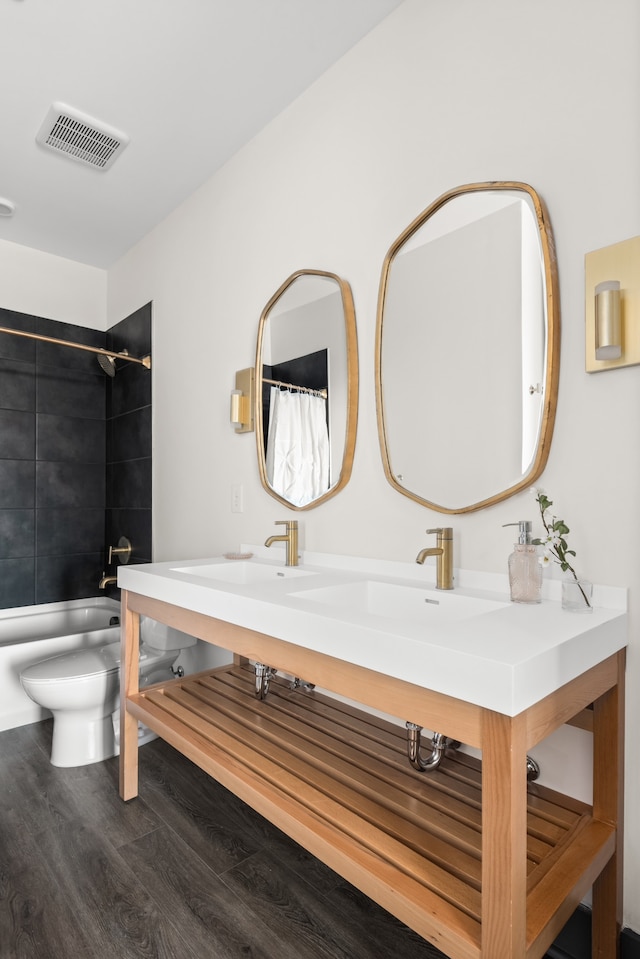 full bathroom featuring a bidet, vanity, hardwood / wood-style flooring, shower / bath combo, and toilet