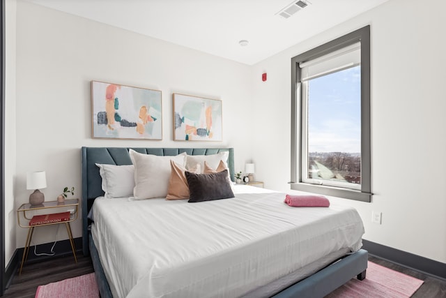 bedroom with dark wood-type flooring