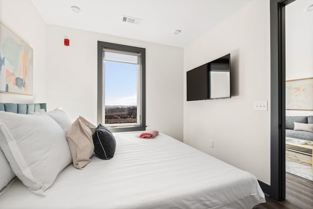 bedroom with dark hardwood / wood-style floors