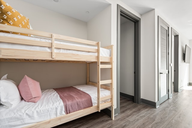 bedroom with a closet and hardwood / wood-style flooring