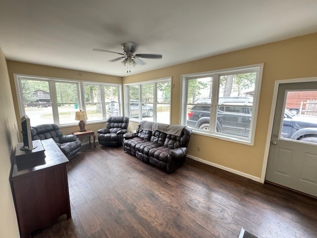 living room featuring a healthy amount of sunlight, ceiling fan, and dark hardwood / wood-style floors