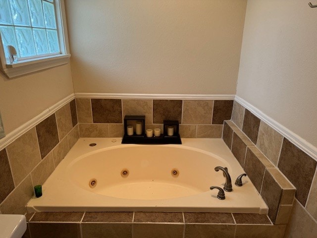 bathroom featuring tiled bath