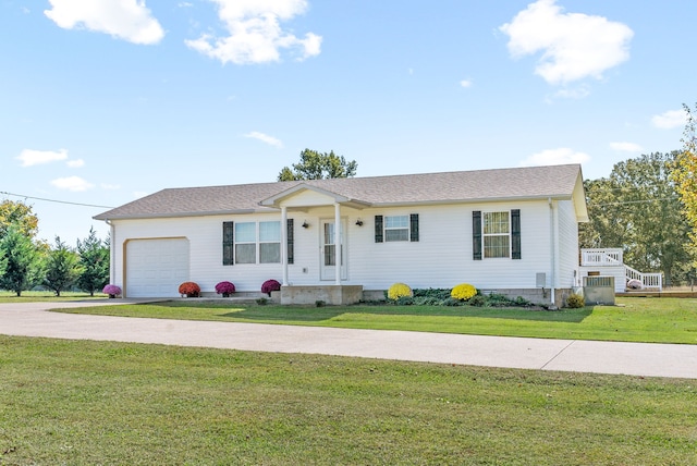 ranch-style home featuring a garage and a front lawn