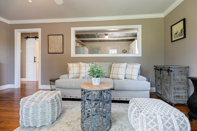 living room featuring wood-type flooring, crown molding, and a barn door