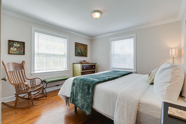 bedroom with ornamental molding and hardwood / wood-style floors