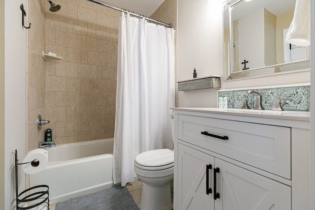 full bathroom featuring tile patterned floors, vanity, shower / bath combo with shower curtain, and toilet