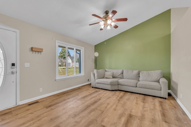 living room featuring light hardwood / wood-style floors, lofted ceiling, and ceiling fan