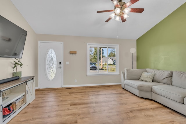 living room featuring ceiling fan, light hardwood / wood-style flooring, and lofted ceiling