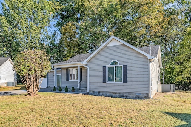 view of front facade with central air condition unit and a front yard