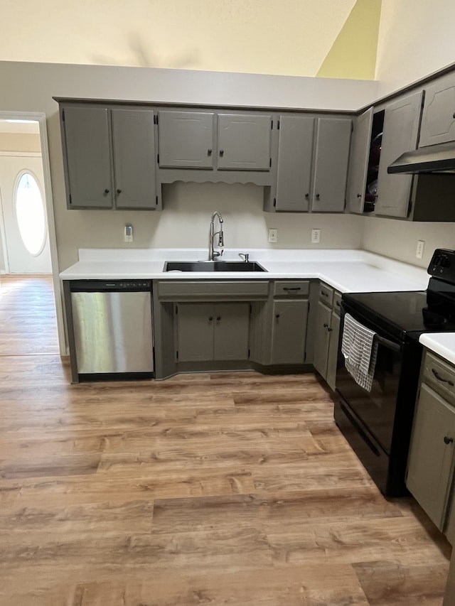 kitchen featuring gray cabinets, stainless steel dishwasher, sink, and black electric range oven