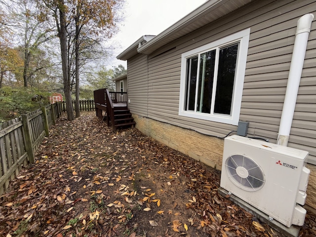 view of home's exterior with a wooden deck and ac unit