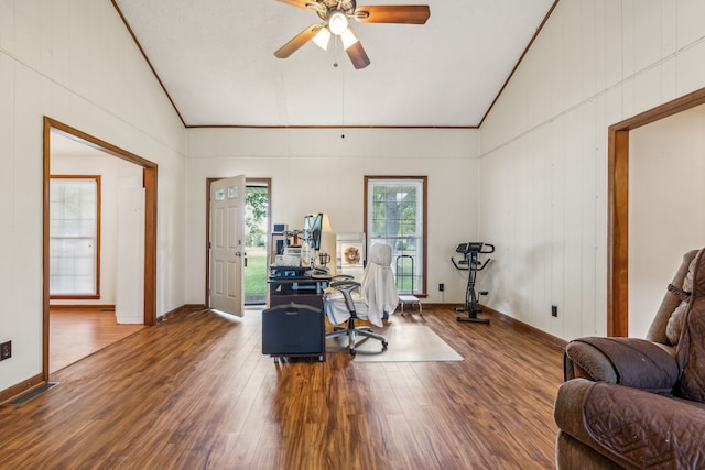 living area with ceiling fan, dark hardwood / wood-style floors, and vaulted ceiling