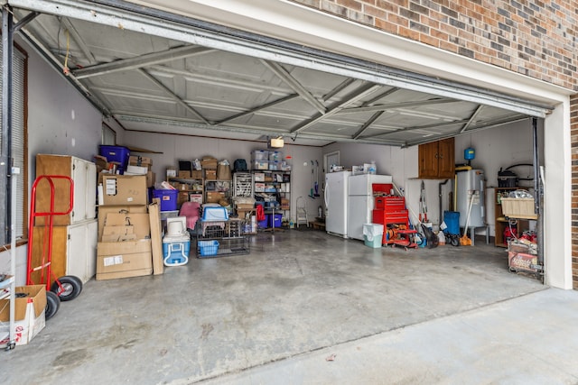 garage with water heater and white refrigerator