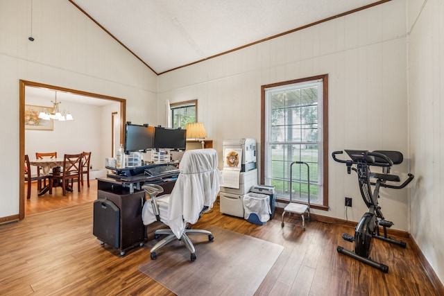 office space featuring an inviting chandelier, wood-type flooring, and vaulted ceiling