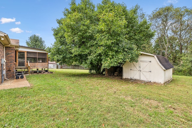 view of yard with a shed and a sunroom