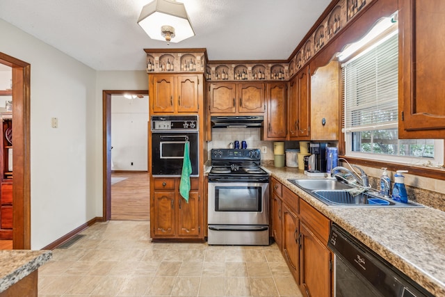 kitchen featuring sink, backsplash, and black appliances