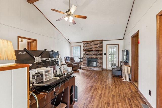 living room with a brick fireplace, vaulted ceiling, dark hardwood / wood-style floors, and ceiling fan