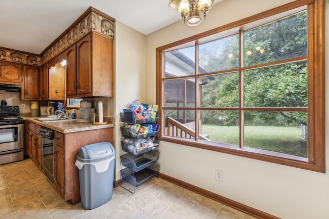 kitchen with backsplash, electric range, and a wealth of natural light