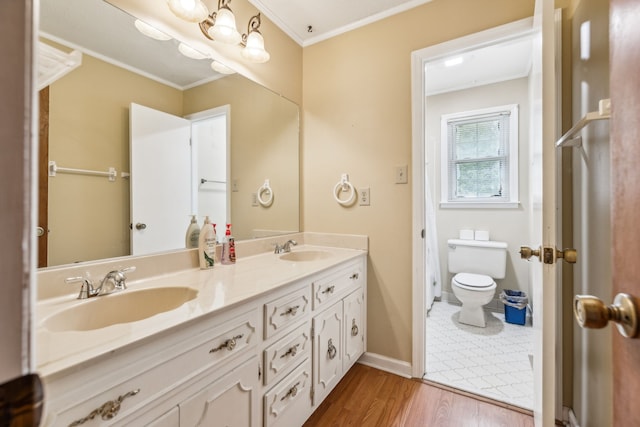 bathroom with ornamental molding, hardwood / wood-style floors, vanity, and toilet