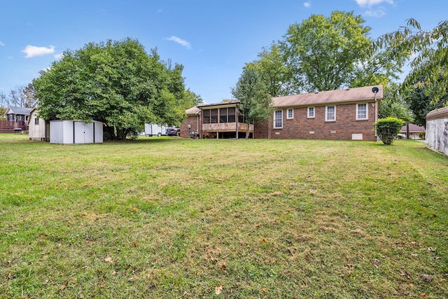 view of yard with a storage shed and a sunroom