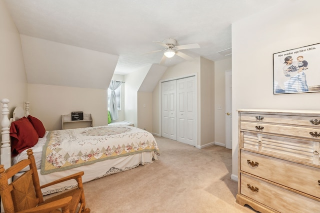 carpeted bedroom with vaulted ceiling, ceiling fan, and a closet