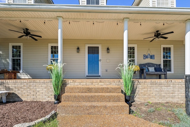 view of exterior entry featuring ceiling fan and covered porch