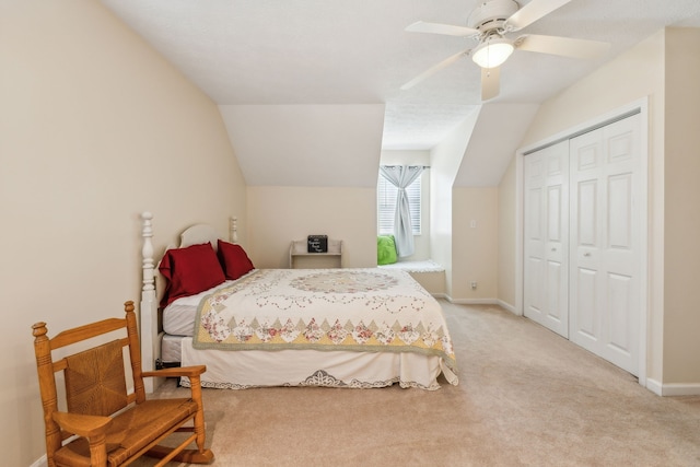 carpeted bedroom featuring lofted ceiling, ceiling fan, and a closet