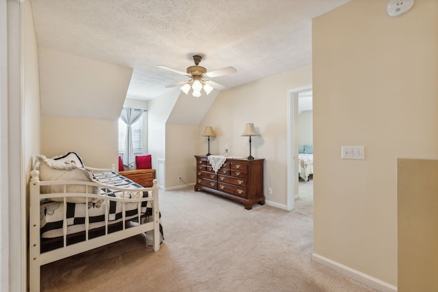 carpeted bedroom featuring lofted ceiling, a textured ceiling, and ceiling fan