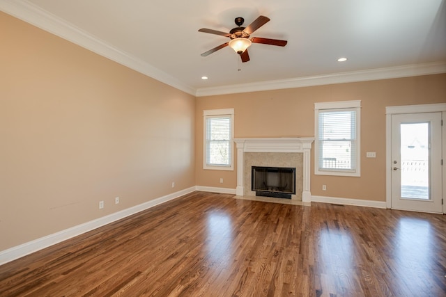 unfurnished living room featuring a fireplace with flush hearth, a ceiling fan, baseboards, and ornamental molding