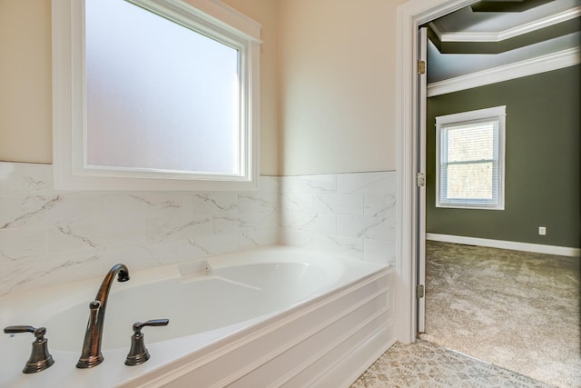 bathroom featuring a garden tub and crown molding