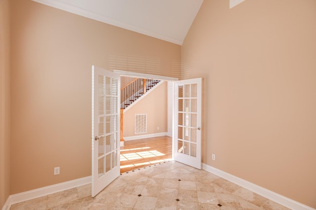 spare room with visible vents, tile patterned flooring, high vaulted ceiling, and french doors