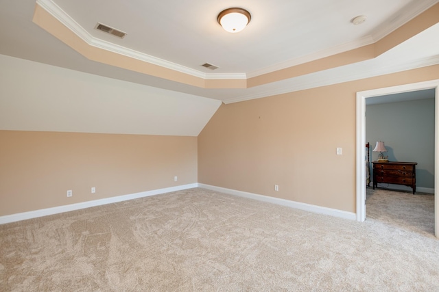 additional living space with light colored carpet, baseboards, and visible vents