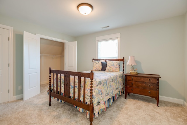 bedroom featuring baseboards, visible vents, a closet, and carpet flooring