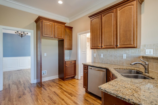 kitchen featuring a sink, light wood-style floors, backsplash, light stone counters, and dishwasher
