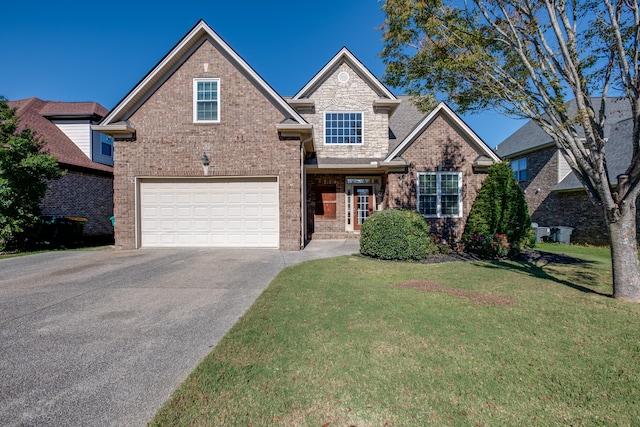 view of front of property featuring a front yard and a garage