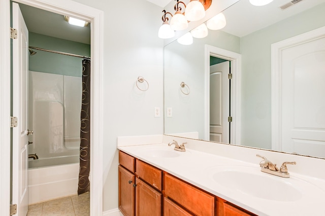 bathroom featuring tile patterned floors, visible vents, a sink, and double vanity