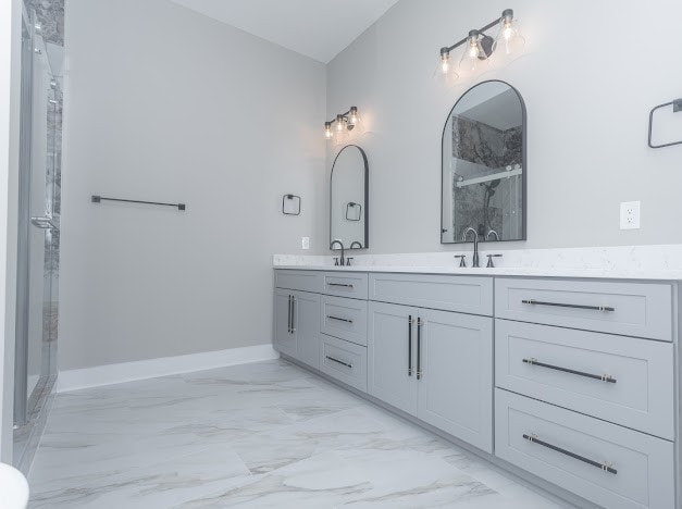 bathroom featuring vanity and a shower with shower door