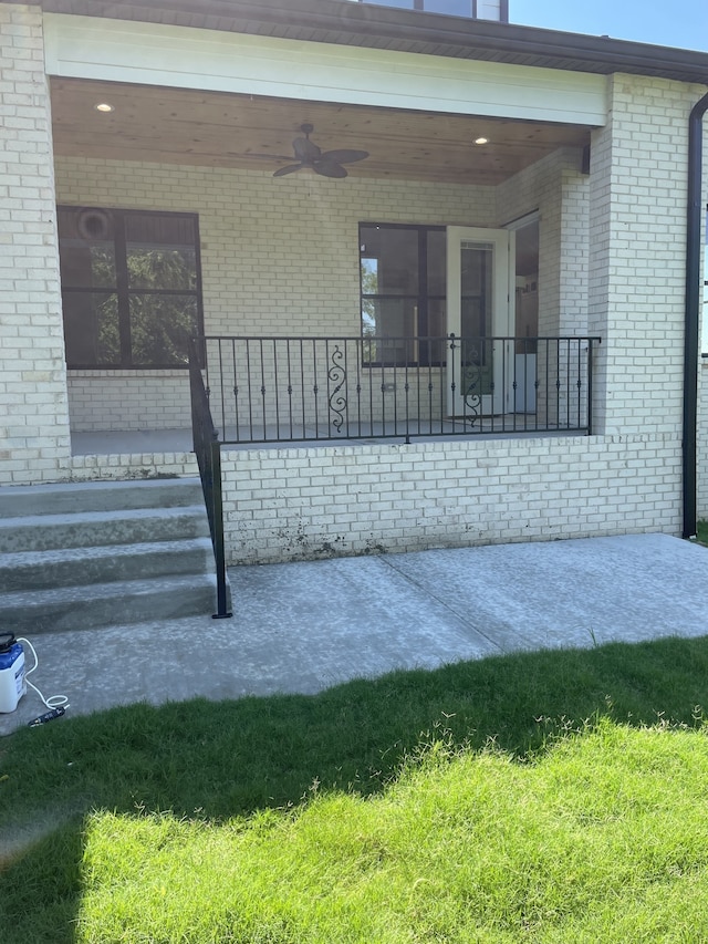 exterior space featuring a yard and ceiling fan