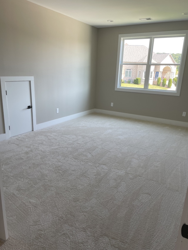 spare room with light colored carpet