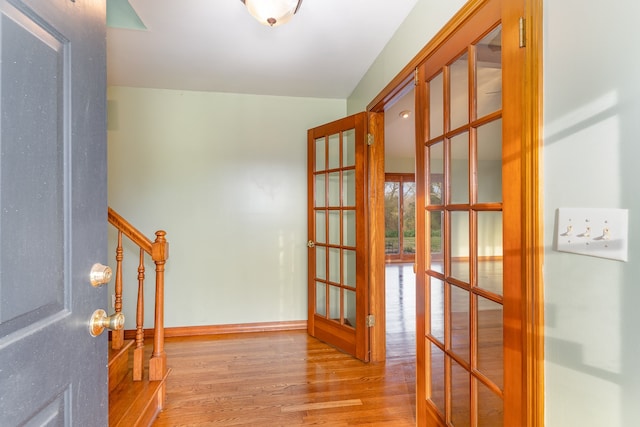 entryway with french doors and light hardwood / wood-style floors