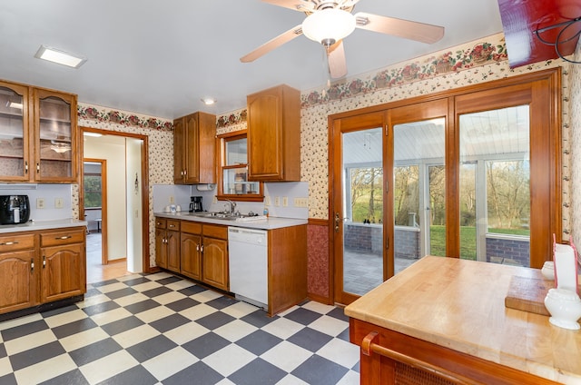 kitchen with ceiling fan, white dishwasher, and sink