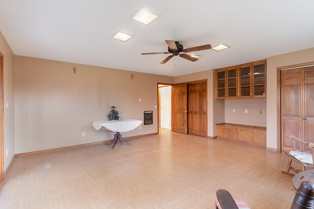 interior space with ceiling fan and light parquet floors