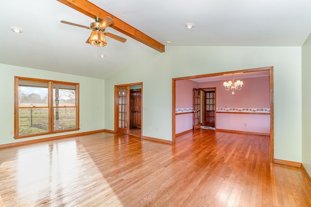 spare room featuring ceiling fan with notable chandelier, hardwood / wood-style flooring, vaulted ceiling with beams, and french doors