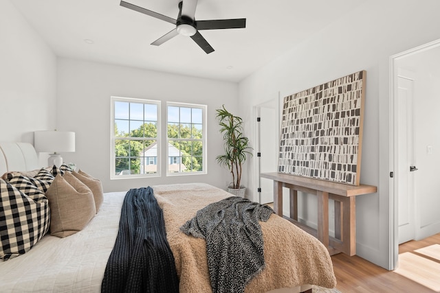 bedroom with ceiling fan and light hardwood / wood-style flooring